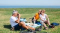 Senior father taking a photo to his family with duck face sitting on a blanket having picnic Royalty Free Stock Photo