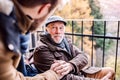 Senior father in wheelchair and young son on a walk. Royalty Free Stock Photo