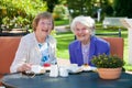 Senior Female Best Friends Relaxing at the Table. Royalty Free Stock Photo