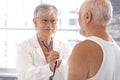 Senior female doctor examining patient Royalty Free Stock Photo