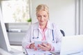 Female doctor using toucpad at the private clinic Royalty Free Stock Photo