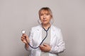 Senior female doctor. Woman medical worker physician holding stethoscope. Medical concept Royalty Free Stock Photo