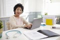 Senior Female Doctor Working At Laptop In Office Royalty Free Stock Photo