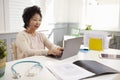 Senior Female Doctor Working At Laptop In Office Royalty Free Stock Photo