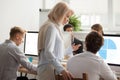 Senior female executive mentor supervising computer work of youn Royalty Free Stock Photo