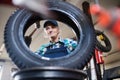 Senior female mechanic repairing a car in a garage. Royalty Free Stock Photo