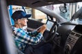 Senior female mechanic repairing a car in a garage. Royalty Free Stock Photo