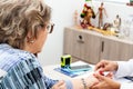 Senior female patient in consultation with a traumatologist female doctor. Skeleton bone disease exam and medic aid. Insurance