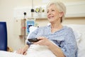 Senior Female Patient Watching TV In Hospital Bed Royalty Free Stock Photo