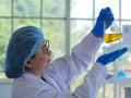 A senior scientist carrying out a flask