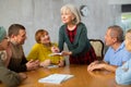 Senior female tutor leading educational class for elderly Royalty Free Stock Photo