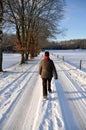 Senior female walking through the snow Royalty Free Stock Photo
