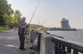Senior fisherman fishing on a Dnepr river embankment