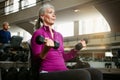 Senior fitness, dumbbell or old woman at gym for training, wellness or cardio with earphones, music or exercise Royalty Free Stock Photo