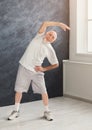 Senior man warmup stretching training indoors Royalty Free Stock Photo