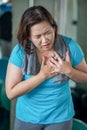 Senior fitness woman suffering from chest pain while exercising in gym. aged lady Heart attack . Old female workout .Mature sport