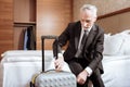 Senior focused man locking luggage Royalty Free Stock Photo