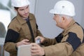 Senior foreman sharing ideas with young builder Royalty Free Stock Photo