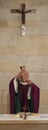 A Senior French Catholic priest is giving mass during a baptism in Aquitaine