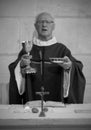 A Senior French Catholic priest is giving mass during a baptism in Aquitaine Royalty Free Stock Photo