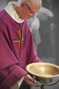 A Senior French Catholic priest is giving mass during a baptism in Aquitaine Royalty Free Stock Photo