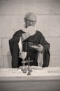 A Senior French Catholic priest is giving mass during a baptism in Aquitaine Royalty Free Stock Photo
