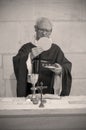 A Senior French Catholic priest is giving mass during a baptism in Aquitaine