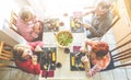 Senior friends eating at home lunch - Happy mature people having a meal together during quarantine isolation - Focus on dishes -