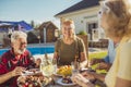 Senior friends eating lunch by the swimming pool Royalty Free Stock Photo