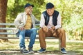 Senior friends, funny and relax at park, talking and bonding outdoor in retirement. Happy elderly men sitting together Royalty Free Stock Photo