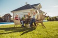 Senior friends having lunch by the swimming pool Royalty Free Stock Photo