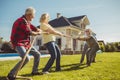 Senior friends participating in rope pulling competition Royalty Free Stock Photo