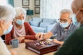 Senior friends playing chinese checkers at nursing home