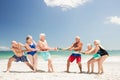Senior friends playing tug of war Royalty Free Stock Photo