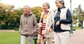 Senior friends, talking and walking together on an outdoor path to relax in nature with elderly women in retirement Royalty Free Stock Photo