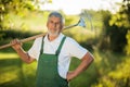 Senior gardener holding a grass rake Royalty Free Stock Photo