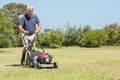 Senior gardener mowing Royalty Free Stock Photo