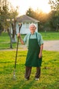 Senior gardener with rake smiling. Royalty Free Stock Photo