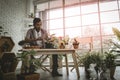 Senior gardener working his houseplant workshop for his small business in plants shop