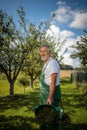 Senior gardenr gardening in his  garden - mowing the lawn Royalty Free Stock Photo