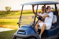 Senior golf`s couple in golf car