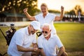 Senior golfers on court. Two men using smart phone Royalty Free Stock Photo