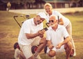 Senior golfers on court. Two men using smart phone Royalty Free Stock Photo