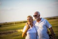 Senior golfers talking and walking on golf course.  Great day for golf and fun Royalty Free Stock Photo