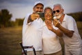 Senior golfers using phone and taking self portrait. Royalty Free Stock Photo