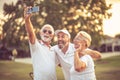 Senior golfers using phone and taking self portrait Royalty Free Stock Photo