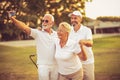 Senior golfers using phone and taking self portrait Royalty Free Stock Photo