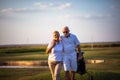 Senior golfers walking on golf course Royalty Free Stock Photo