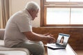 Senior man talk with smiling granddaughter on video call