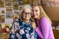 Young woman spending time with her elderly grandmother at home